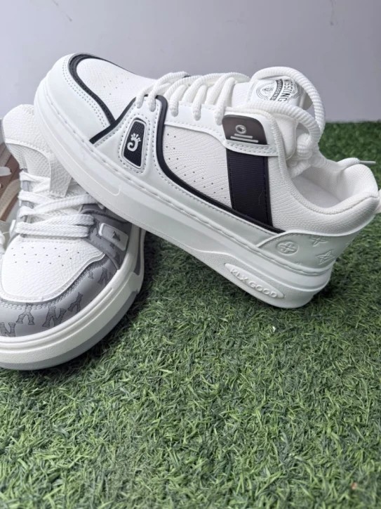 Stacked unisex designer sneakers showing white black, grey monogram, and beige designs