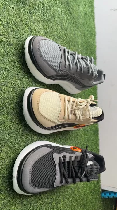 Men's chunky mesh sneakers in grey, beige, and black — wholesale display